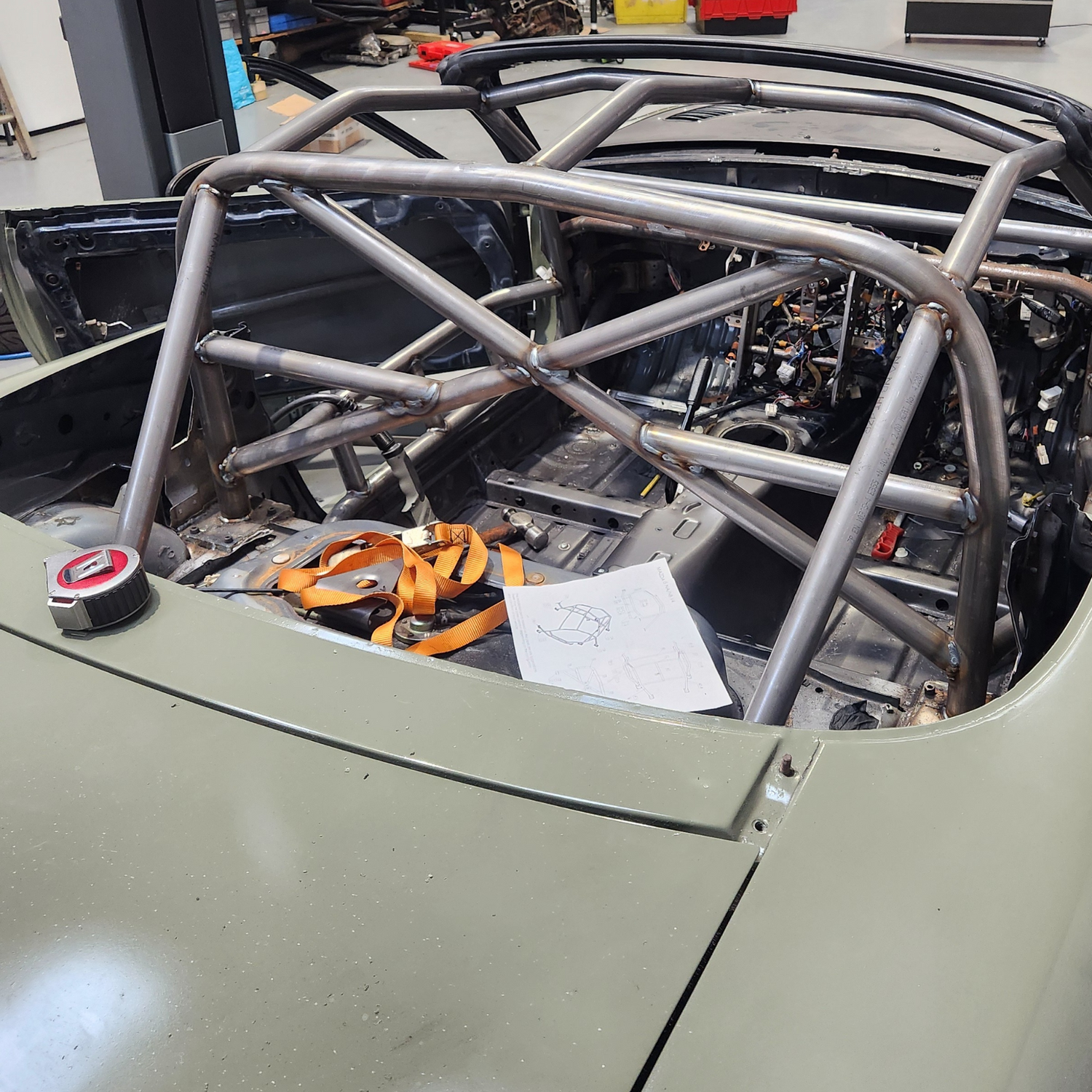 Roll cage installation on mazda mx-5. Stripped interior, fully welded roll cage.