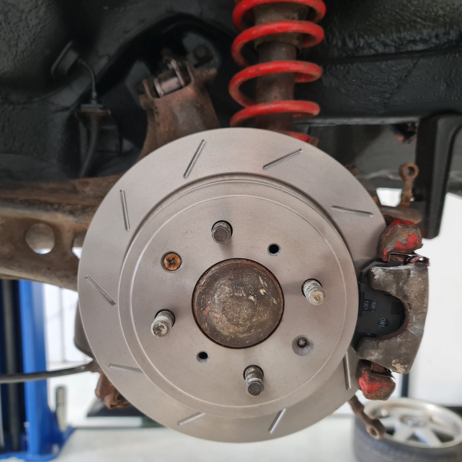 Brand new discs and pads fitted to the rear of the vehicle, showing brake servicing. 